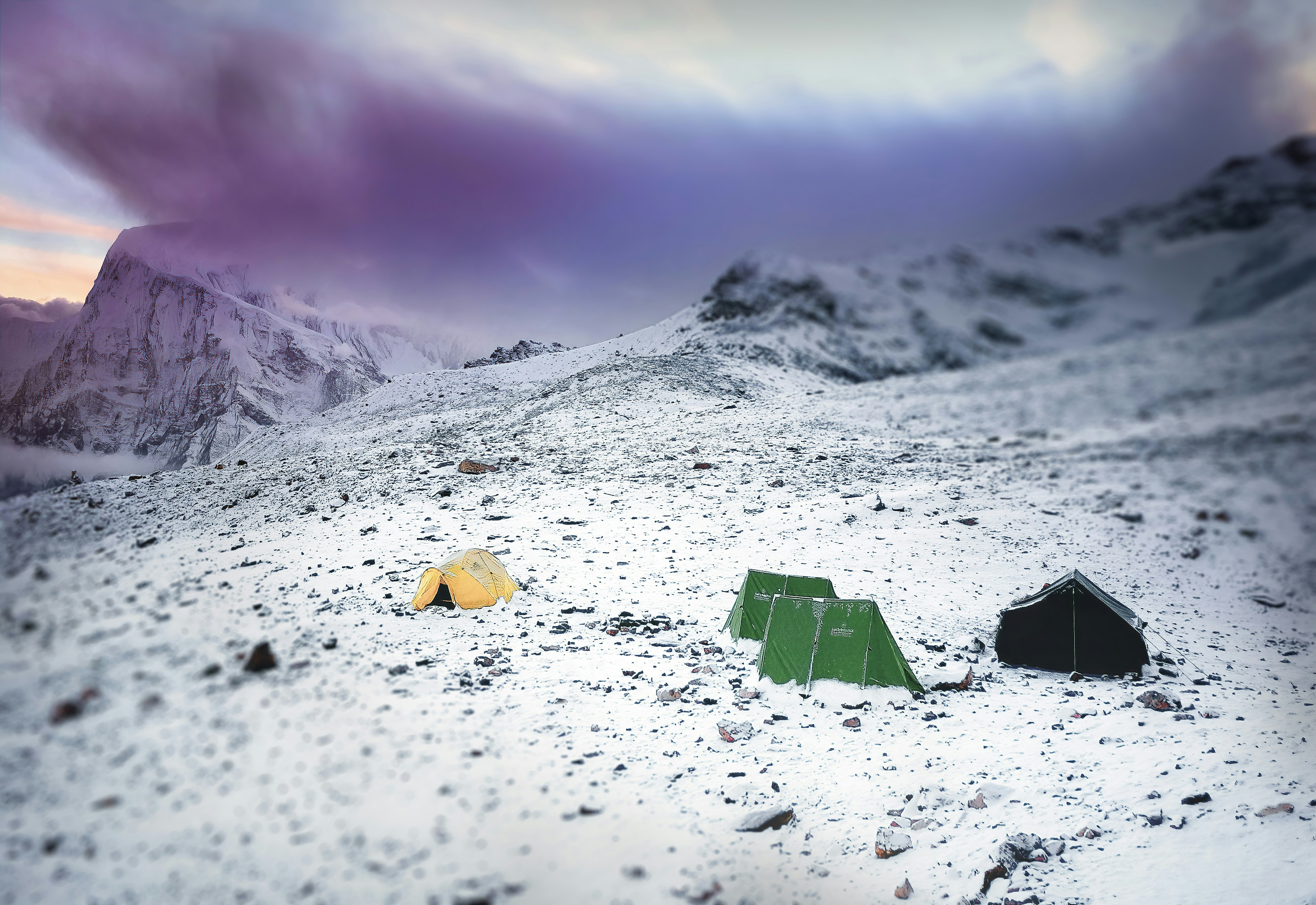 green and yellow camping tent in the middle of icy surface